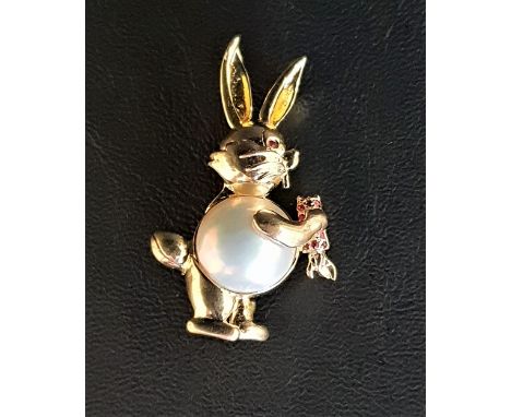 MABE PEARL SET RABBIT BROOCHin fourteen carat gold with ruby eye and ruby set carrot, 4.2cm high and approximately 8.4 grams 