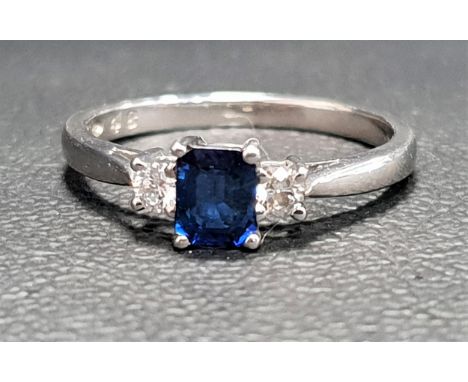 SAPPHIRE AND DIAMOND THREE STONE RINGthe central emerald cut sapphire approximately 0.4cts flanked by round cut diamonds tota