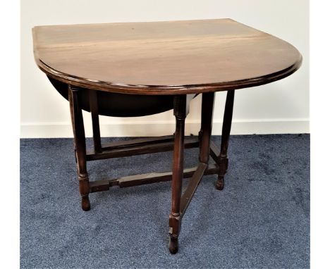 OAK GATE LEG DINING TABLEwith shaped drop flaps, standing on turned supports, 91.5cm wide 