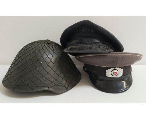EAST GERMAN OFFICERS CAPin grey felt, marked to the interior NVA57 1856Y, an East German military helmet with green netting a