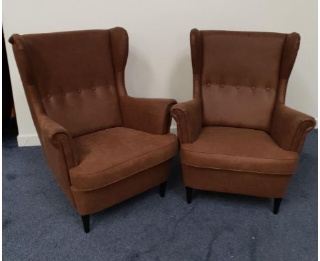 PAIR OF RETRO STYLE WING BACK ARMCHAIRSin brown leather effect with button backs, scroll arms and padded shaped seats, standi
