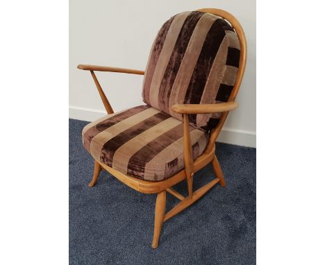 ERCOL BEECH ARMCHAIRwith an arched spindle back above shaped arms, with a loose back and seat cushion, standing on turned sup