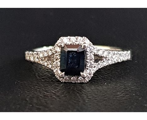 SAPPHIRE AND DIAMOND CLUSTER RINGthe central emerald cut sapphire approximately 0.4cts in diamond surround and with further d