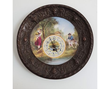 DECORATIVE WALL CLOCKwith a central painted panel depicting figures by a stream in a metal surround with raised mask and moti
