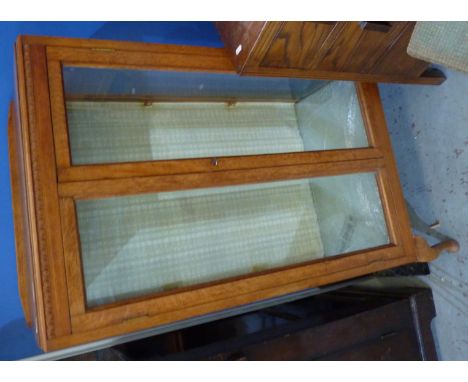 Light oak china cabinet enclosed by 2 glazed doors