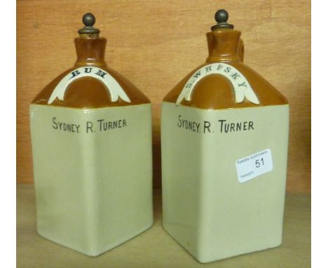 Pair of stoneware jugs with stoppers inscribed 'Rum' and 'S.Whisky' named Sydney R Turner