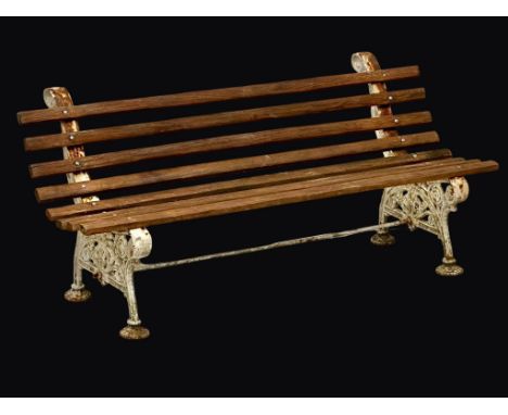 A Victorian cast iron garden bench with later teak straps. Circa 1860. 152cm 