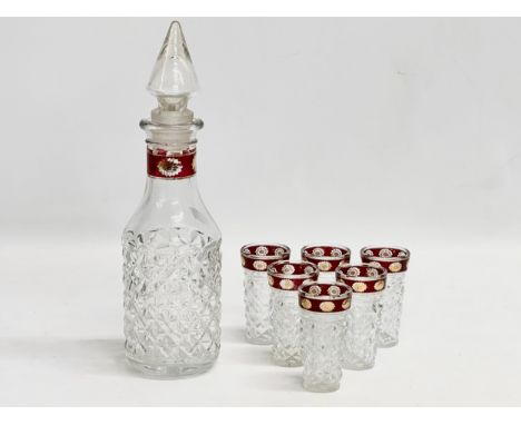A vintage Italian drinks set. Decanter 28cm. Glasses 8cm. Stamped Made in Italy. 