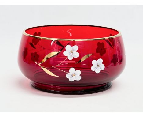A mid 20th century Bohemian Ruby Glass fruit bowl with embossed painted flower and gilt rim. 17x9cm 
