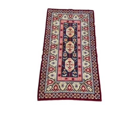 A large vintage Middle Eastern style wool rug. 229x123cm 