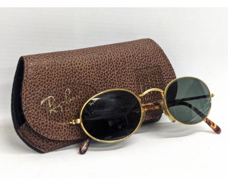 A pair of Ray Ban USA sunglasses with Bausch Lomb lens. John Lennon gold frames. With original case. 