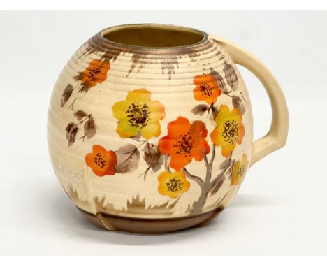 An early 20th century Art Deco jug. In the Clarice Cliff ‘Rhodanthe’ style. 18x14x14cm 