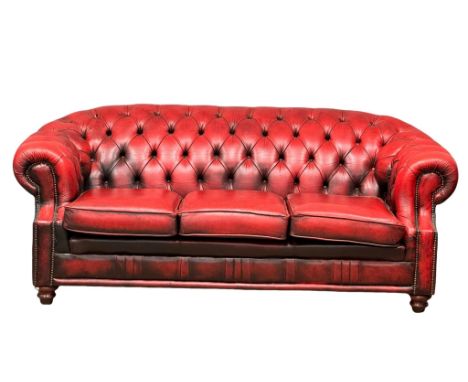 A deep buttoned ox-blood leather Victorian style 3 seater sofa. 207cm 