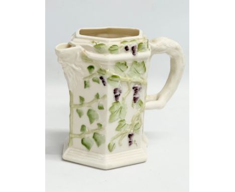 A 4th period Belleek pottery ‘Bacchus’ jug with grape vines and leaves. Early/mid 20th century. 17x9x14.5cm 