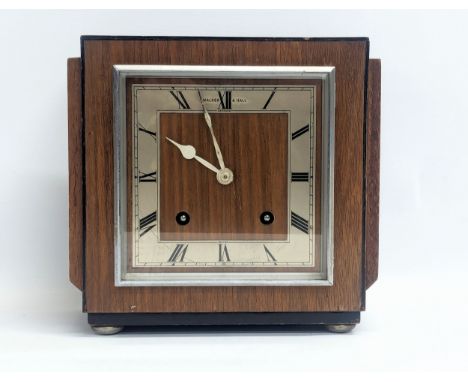 An Art Deco Walker &amp; Hall walnut mantle clock on chromed feet. Circa 1930-1950. With pendulum. 22x21cm 