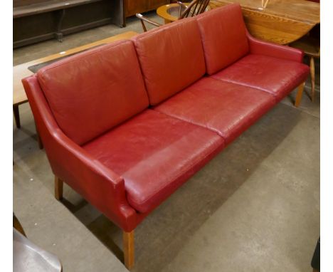 A Danish Thams Kvalitet crimson leather three seater sofa, designed by Rud Thygesen 