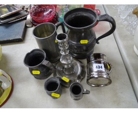 Interesting pewter candlestick and a selection of various sized tankards