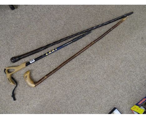 African carved hardwood cane, a modern Leki extending walking stick and one other