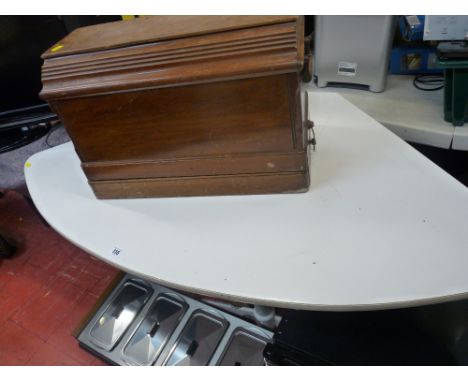 Retro style corner table on metal supports and a cased manual Singer sewing machine