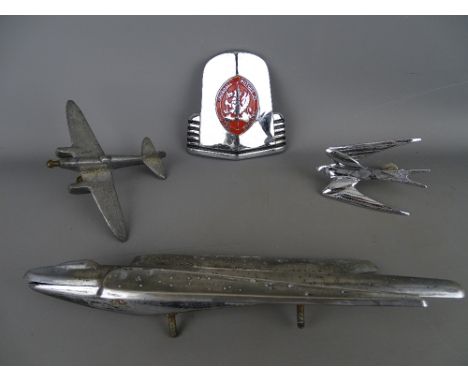 Collection of chrome plated bonnet and grill mount mascots including a stylized bird and plane, a spitfire type model and a V