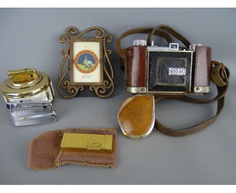 Leather cased Kodak vintage camera, four vintage lighters and a modern portrait frame containing a silk card 'Arms of Ceylon'