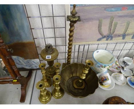 Brass oil lamp base, a selection of brass candlesticks and a bowl