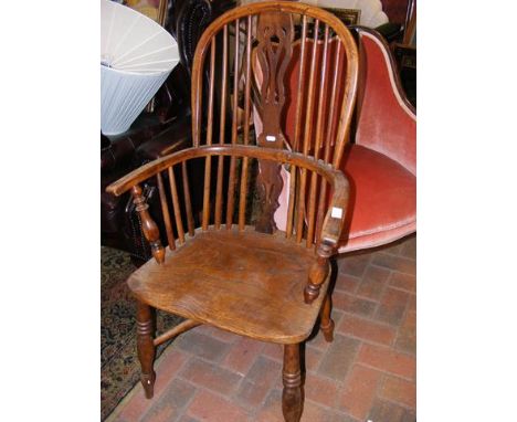 An antique stick back country chair with crinoline stretcher  