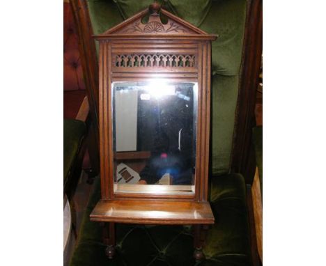 An antique mirrored back shelf 