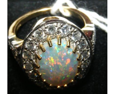 An opal and diamond cluster ring - the opal approx. 1.5 carat - the diamonds approx. 1 carat total - in 18ct gold setting 