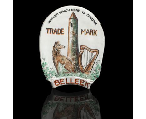 AN BELLEEK EARTHENWARE ADVERTISING WALL PLAQUECirca 1900Of oval form and painted in colours, depicting an Irish wolfhound, ha