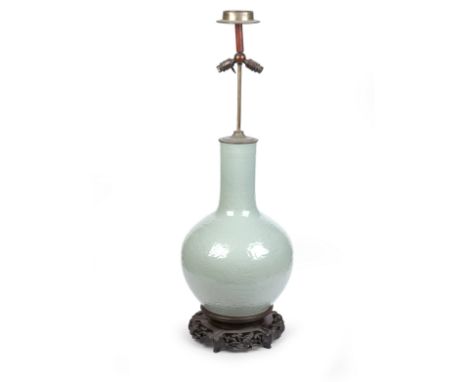A MASSIVE CHINESE CELADON BOTTLE VASE19th/20th CenturyConverted to a lamp, the celadon vase moulded in low relief with dragon