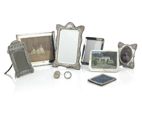 NINE SILVER PHOTO FRAMESThe largest with moulded rectangular frame, Birmingham 1913, 33cm wide, and including a South Indian 