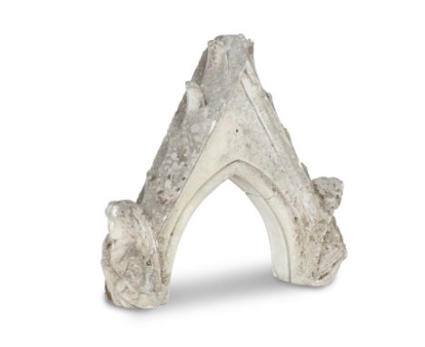 A GOTHIC CARVED LIMESTONE ARCHITECTURAL ELEMENTIn the form of a pointed arch carved with flanking angels, 70cm wide, 18cm dee