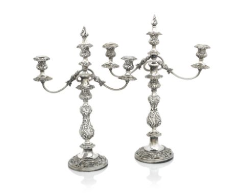 A PAIR OF VICTORIAN SHEFFIELD PLATE THREE-LIGHT CANDELBRAWith flame finials, fluted scrolling arms and floral embossed balust