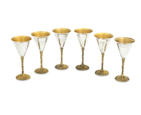 A SET OF SIX ELIZABETH II PARCEL GILT GOBLETSStuart Devlin, London 1975The narrow hammered bowls on lava textured stem and fe