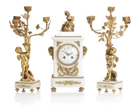 AN EARLY 20TH CENTURY FRENCH WHITE MARBLE AND GILT BRASS CLOCK GARNITUREThe clock with circular Arabic numeral floral dial su