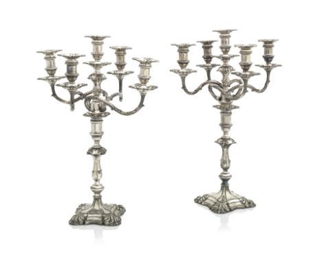 A PAIR OF VICTORIAN ELECTROPLATED FIVE LIGHT CANDELABRAIn George II style with shell moulded square bases and scrolling branc