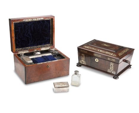 A VICTORIAN AMBOYNA AND EBONY DRESSING CASEThe hinged cover opening to reveal a fitted interior having silver plated and glas