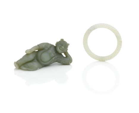 A CELADON JADE FIGURE18th/19th centuryShown resting lying down and resting on one elbow and with a contented expression, 11.7