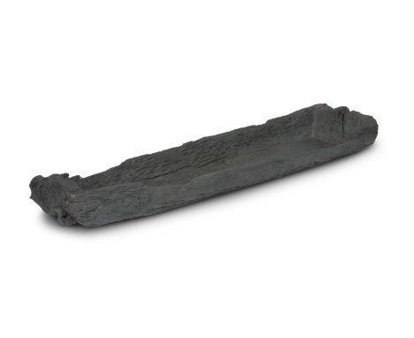  AN IRISH NEOLITHIC BOG OAK DUGOUT CANOE Of typically carved form from a single log timber, some losses, 209cm long, 60cm wid