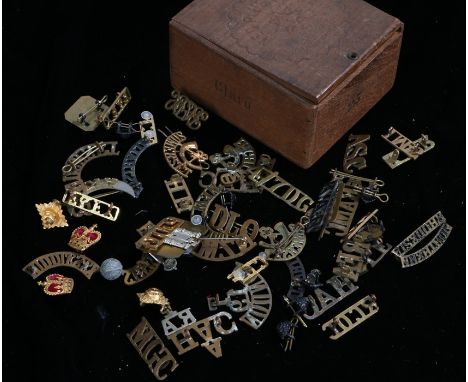 Collection of British and Commonwealth metal shoulder titles including The Royal Scots, Highland Light Infantry, 11th Hussars
