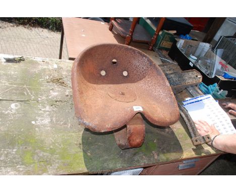 A rusty old tractor seat.