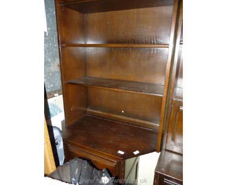 An Ercol dark-wood corner dresser.