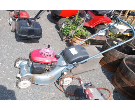A Honda petrol engined rotary lawn-mower in easy-starting running order.