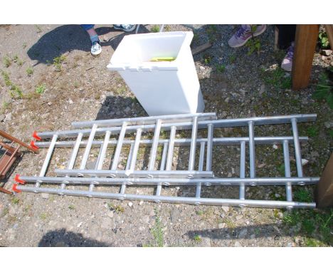 A sectional extending aluminium ladder in 6 sections with a total of 20 rungs and a tub of fittings/accessories.
