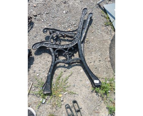 A pair of cast iron bench ends with heart pattern.