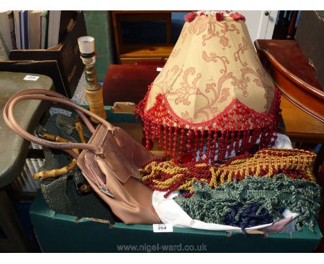 A bag of haberdashery and upholstery edging and a lamp shade.