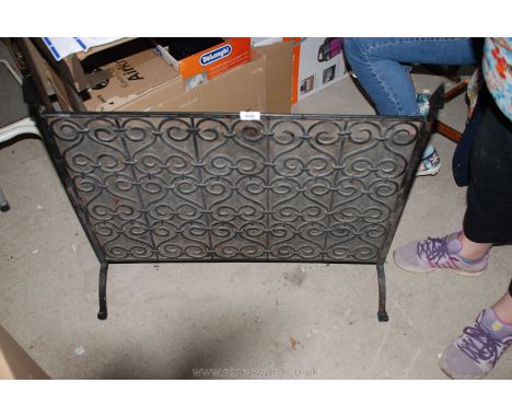 A large metal fireguard., 32'' wide x 28'' tall