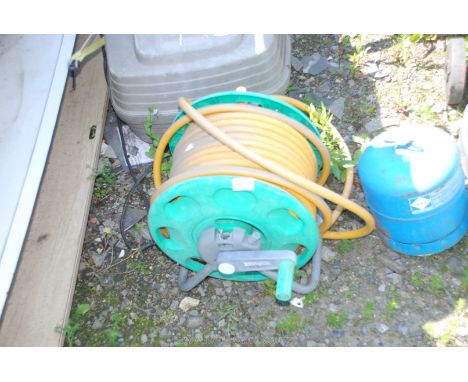 A garden hose-pipe and reel.
