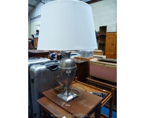 A metal lamp and shade.